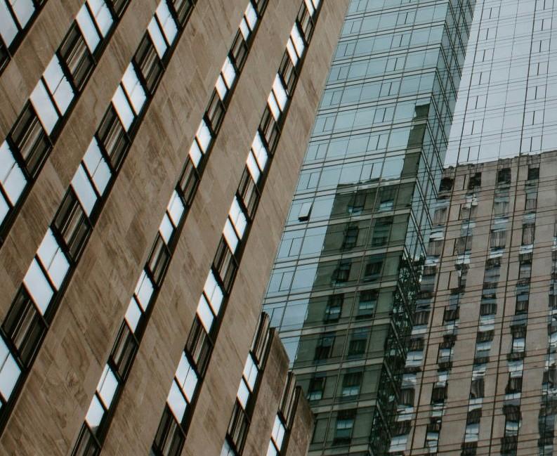 Looking up a glass and stone urban canyon